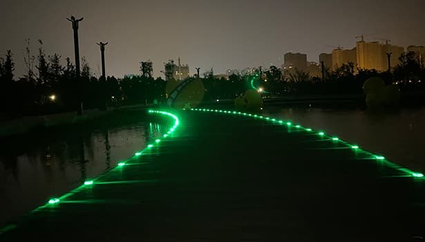 Solar road studs illuminating the pedestrian path