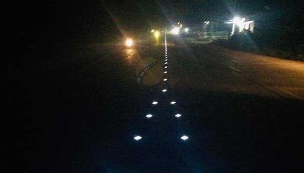 Solar LED road studs guiding vehicles at an intersection